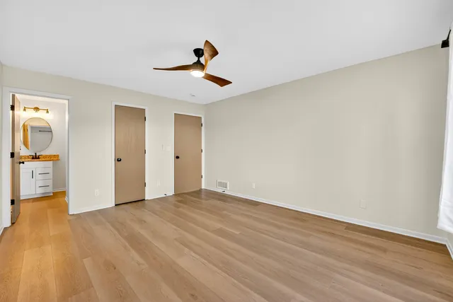 a view of an empty room and wooden floor