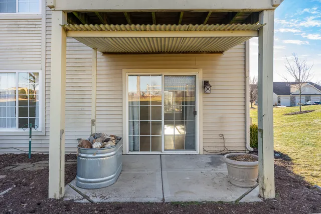 a view of a porch with dining table and chairs