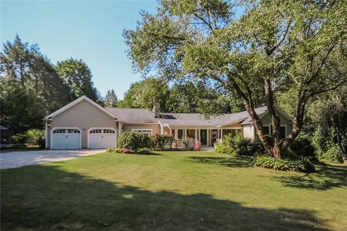 227 Westport Road Wilton, CT 06897 - Photo 1 of 1 a front view of a house with garden and trees