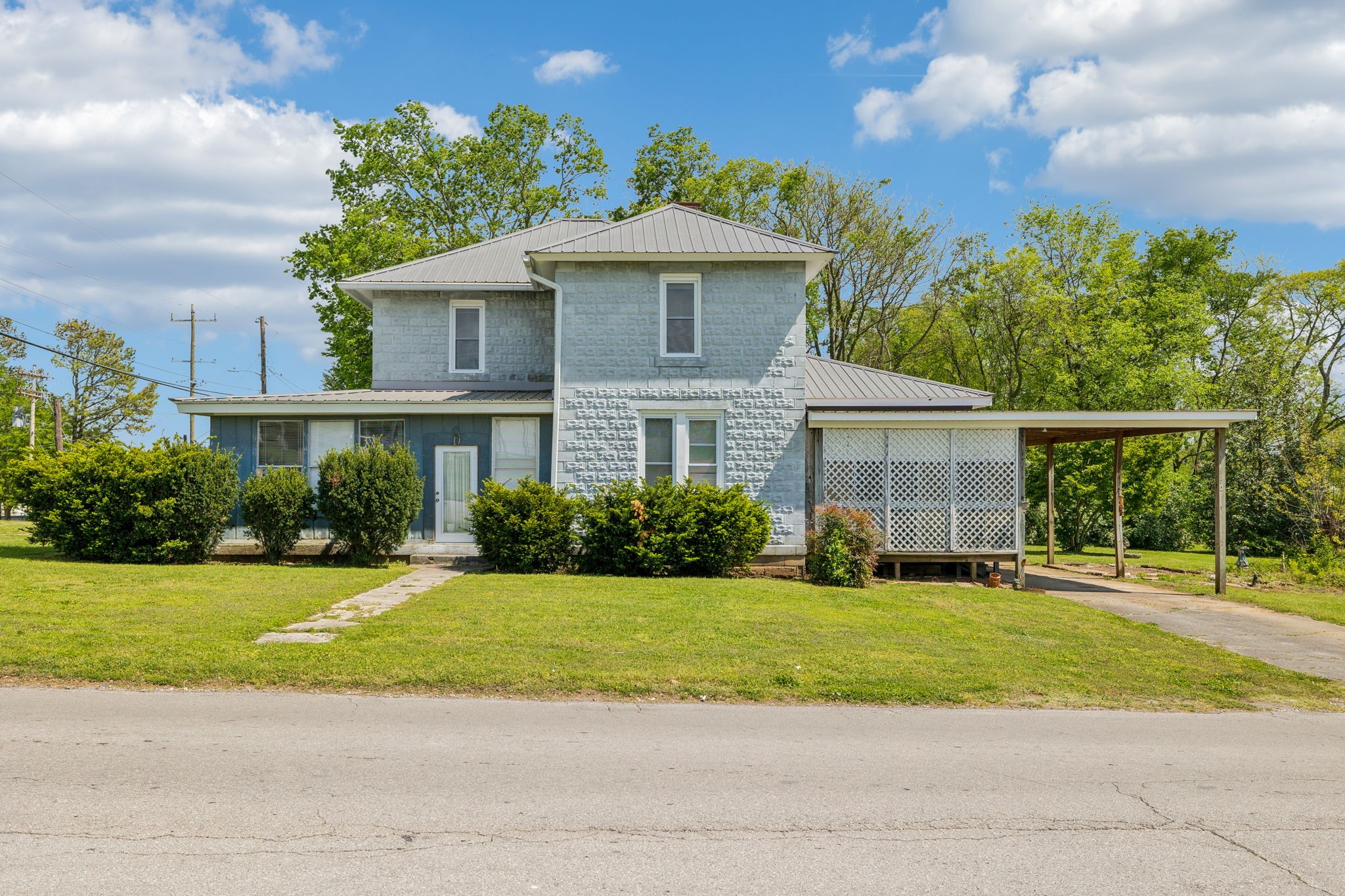 611 1st Avenue Mount Pleasant, TN 38474 - Photo 5 of 33 a front view of a house with a yard and potted plants