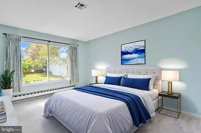 a bedroom with a large bed and a large window