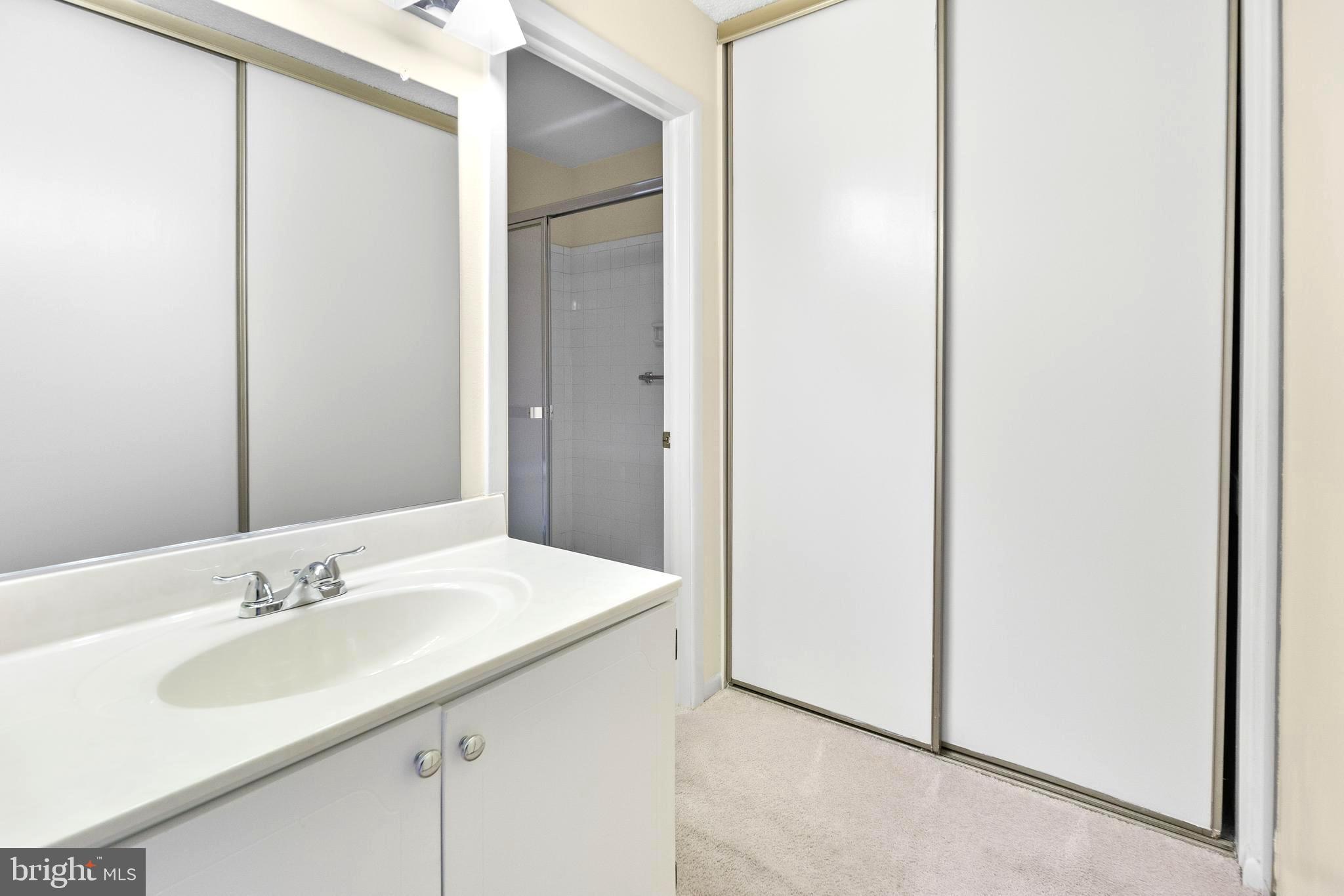 15524 Prince Frederick Way, Unit 118A Silver Spring, MD 20906 - Photo 19 of 31 a bathroom with a sink and a mirror