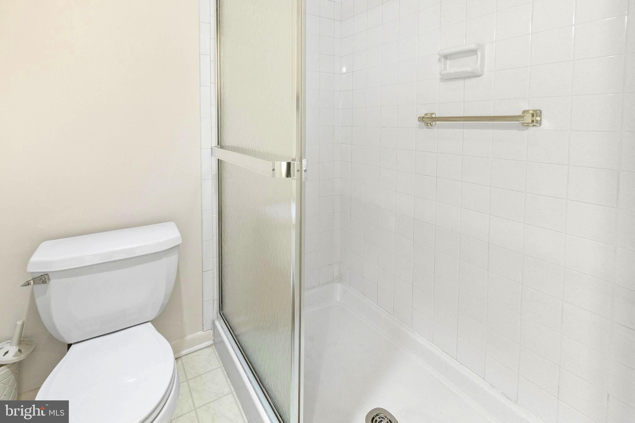15524 Prince Frederick Way, Unit 118A Silver Spring, MD 20906 - Photo 20 of 31 a white toilet sitting next to a shower