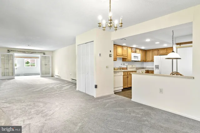 a view of kitchen with sink and refrigerator
