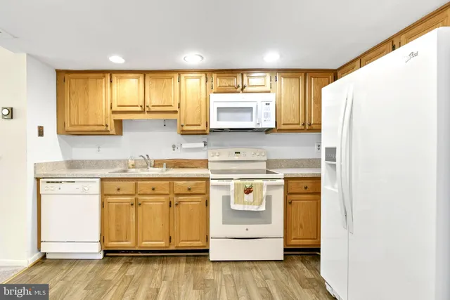 a kitchen with a stove a sink and a microwave