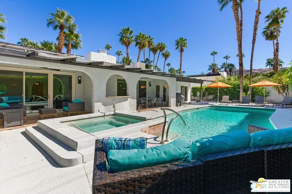 a view of a house with swimming pool and a yard