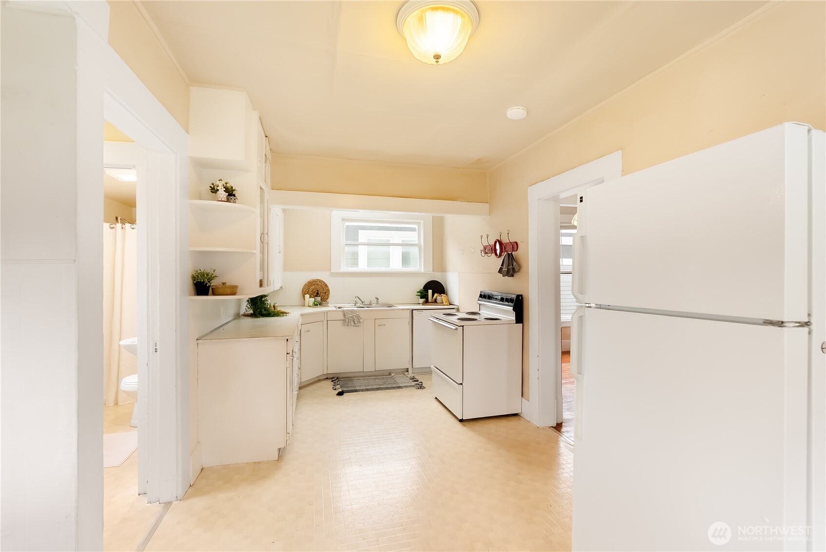 2414 Elm Street Bellingham, WA 98225 - Photo 17 of 36 a white refrigerator freezer sitting in a kitchen