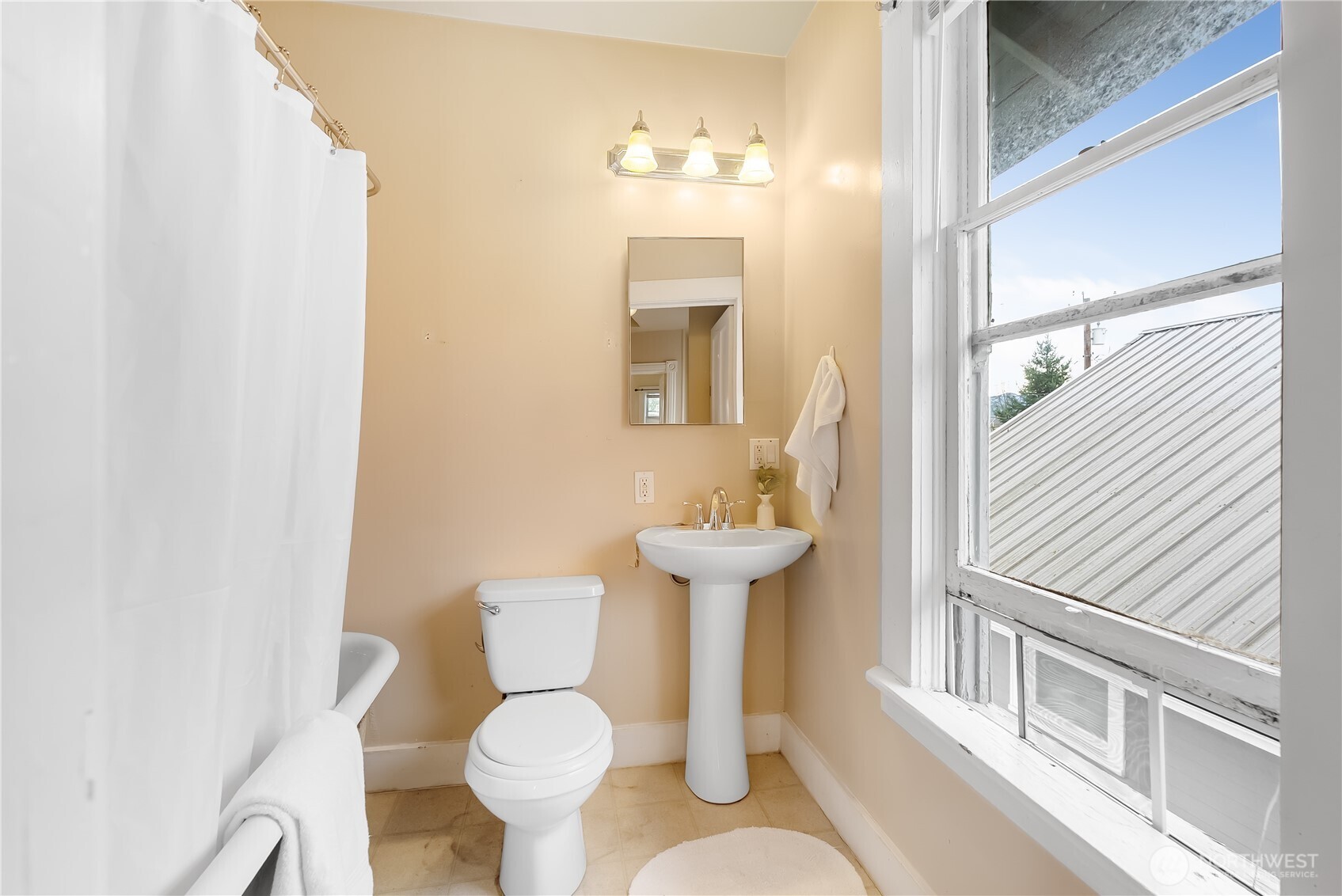 2414 Elm Street Bellingham, WA 98225 - Photo 25 of 36 a bathroom with a sink toilet and mirror