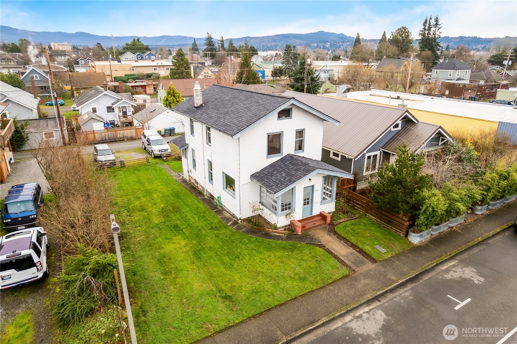 2414 Elm Street Bellingham, WA 98225 - Photo 32 of 36 a view of a house with a big yard and large trees