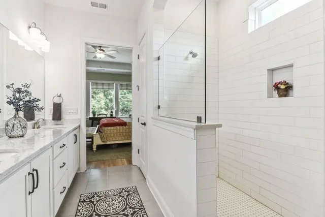 a bathroom with a double vanity sink a mirror and shower