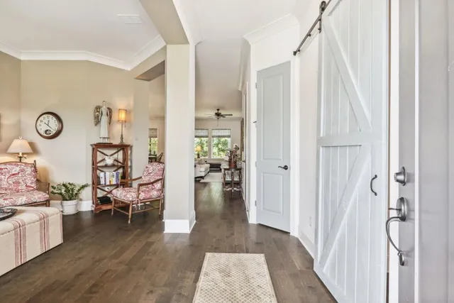 a hallway with wooden floor and furniture