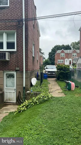 a view of a house with a backyard and a garden