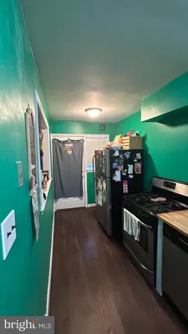 a kitchen with stainless steel appliances granite countertop a refrigerator and a stove