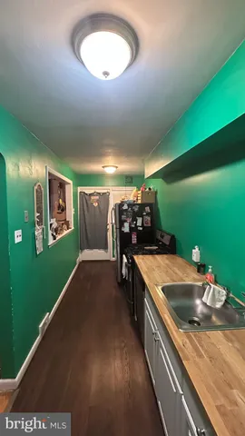 a kitchen with a sink and living room