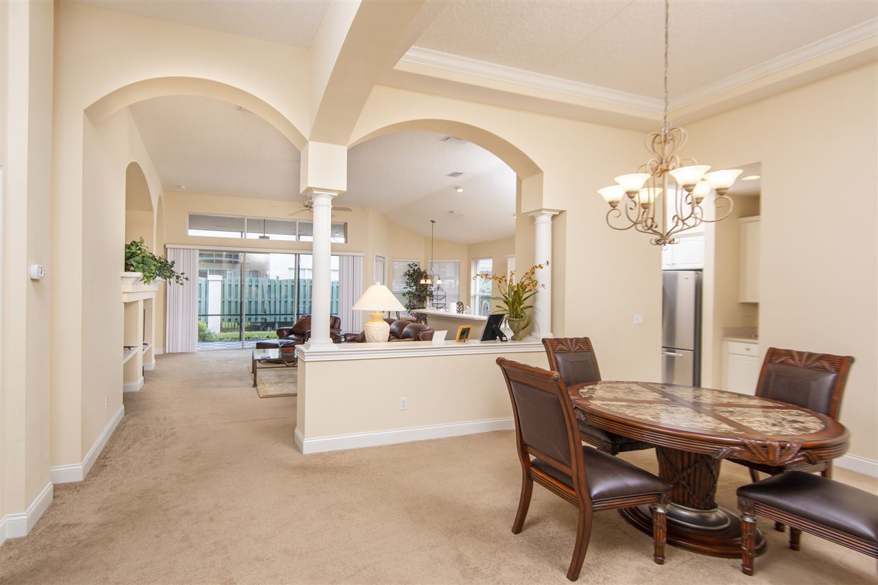 128 St Andrews Pl Drive St. Augustine, FL 32092 - Photo 12 of 38 a dining room with furniture a chandelier and wooden floor