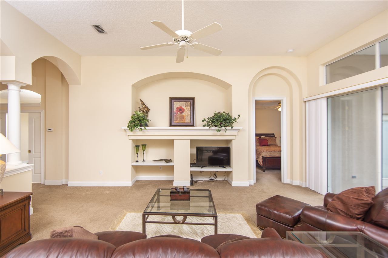 128 St Andrews Pl Drive St. Augustine, FL 32092 - Photo 16 of 38 a living room with furniture and a fireplace
