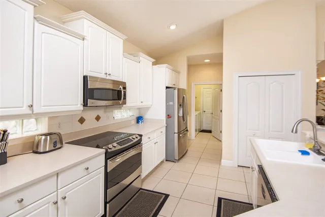 a kitchen with a sink a stove and refrigerator