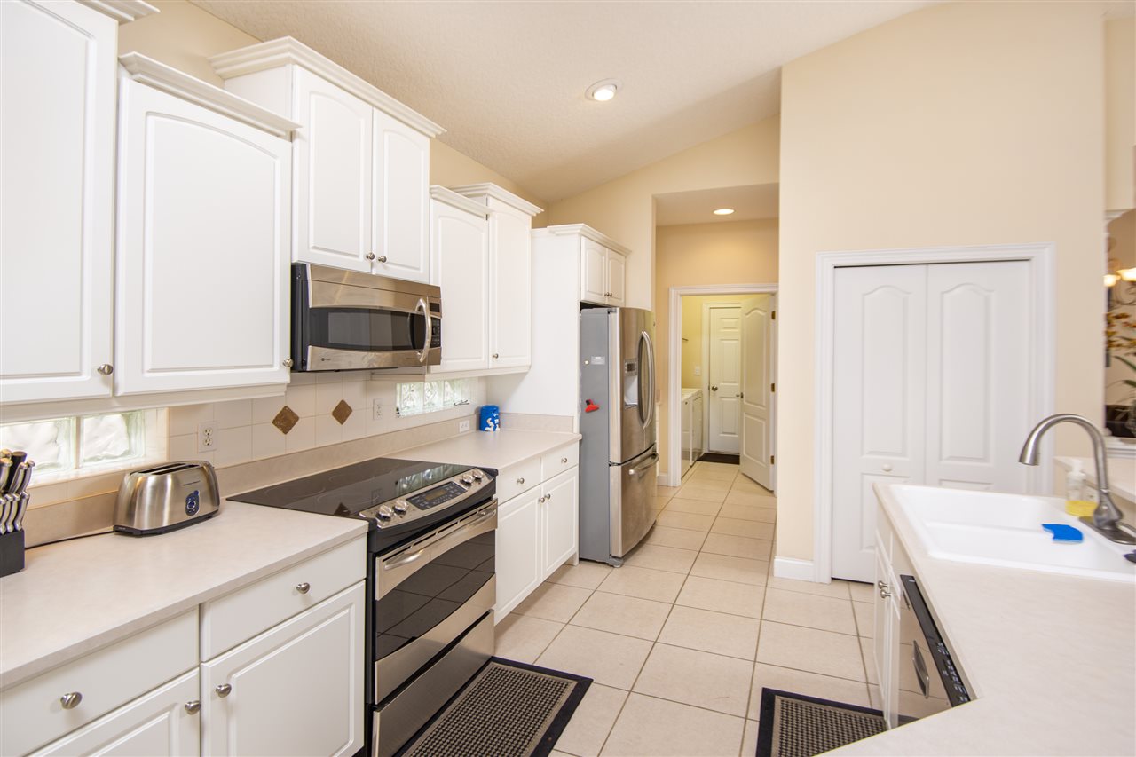 128 St Andrews Pl Drive St. Augustine, FL 32092 - Photo 18 of 38 a kitchen with a sink a stove and refrigerator