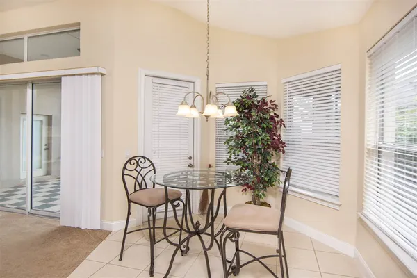 a view of a dining room with furniture and chandelier