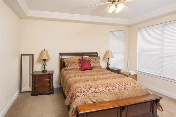 a bedroom with a bed and a chandelier