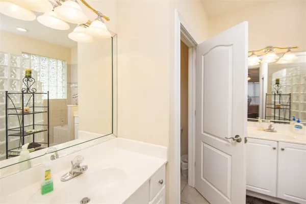 a bathroom with a tub sink and mirror