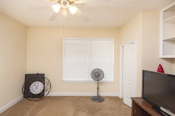 a view of a hallway with a chandelier fan