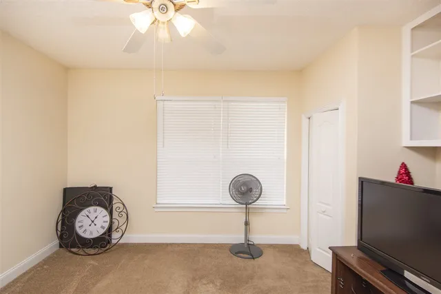 a view of a hallway with a chandelier fan