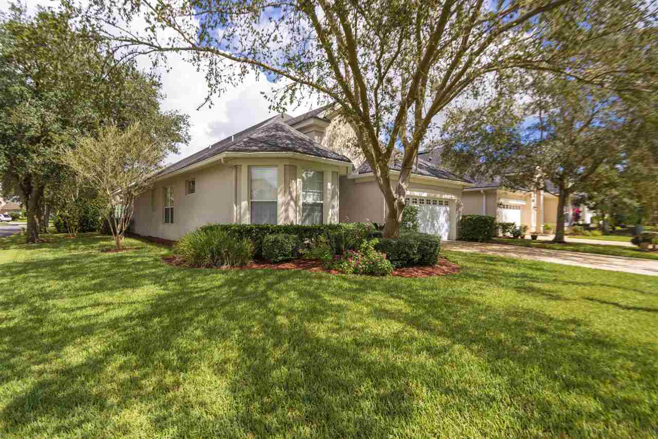 128 St Andrews Pl Drive St. Augustine, FL 32092 - Photo 4 of 38 a white house that has a tree in front of it
