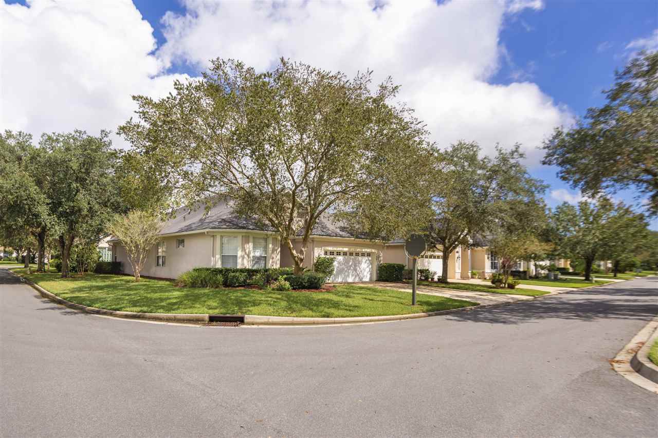 128 St Andrews Pl Drive St. Augustine, FL 32092 - Photo 6 of 38 a front view of a house with a garden and trees