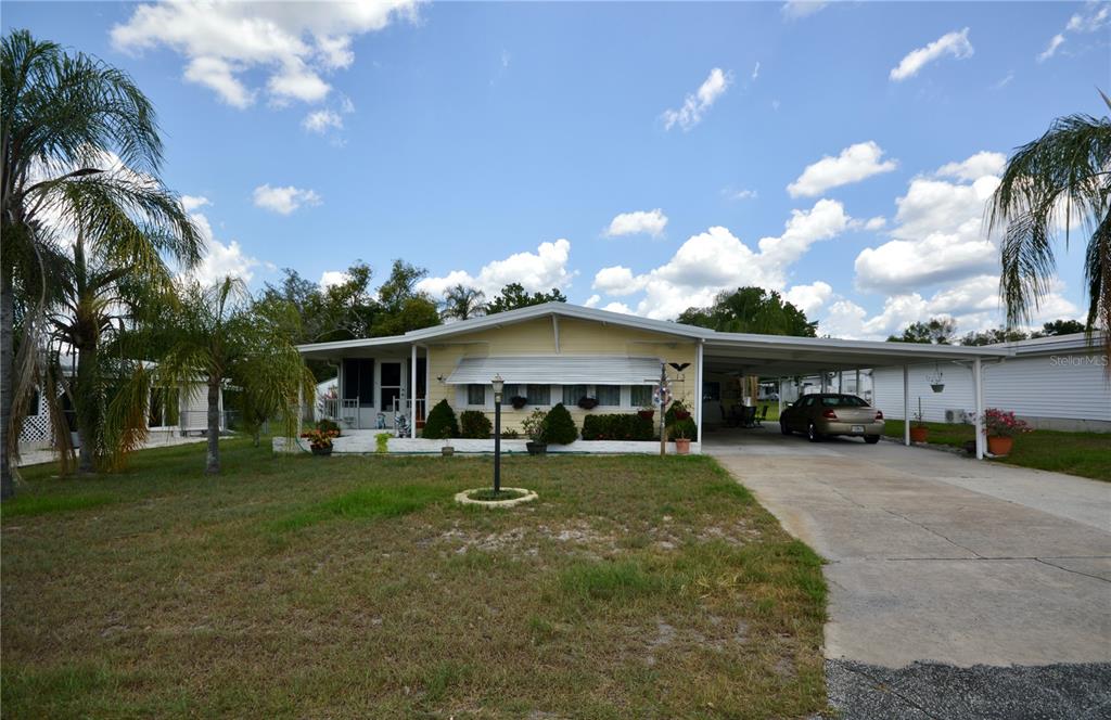 a front view of house with yard and outdoor seating