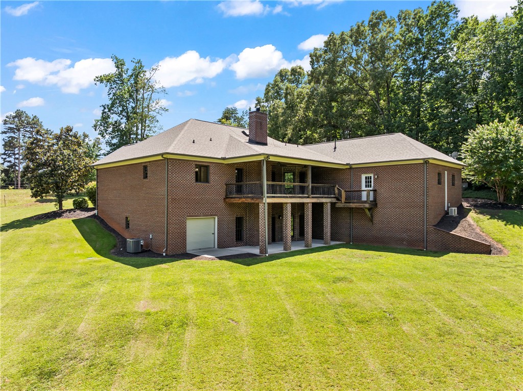 579 Terrapin Crossing Road Pickens, SC 29671 - Photo 2 of 50 A classic brick exterior offers generous yard space, a covered porch, and a basement level garage door.