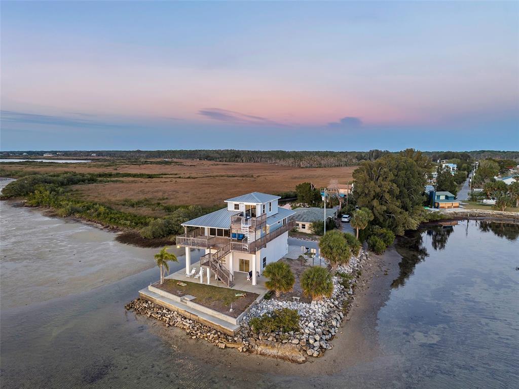 an aerial view of a house with lake view