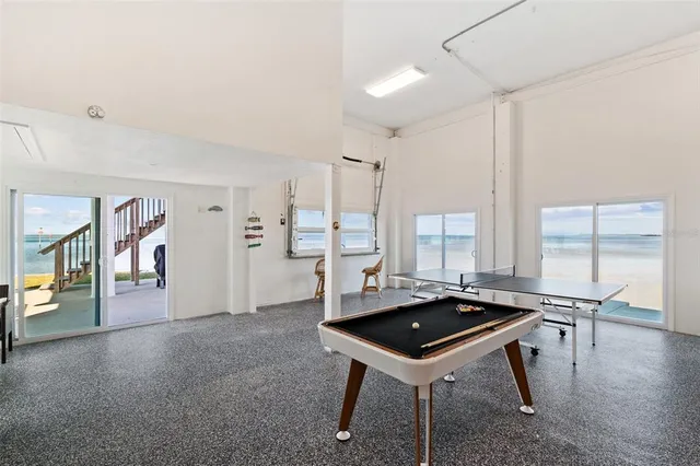 a workspace room with wooden floor and windows