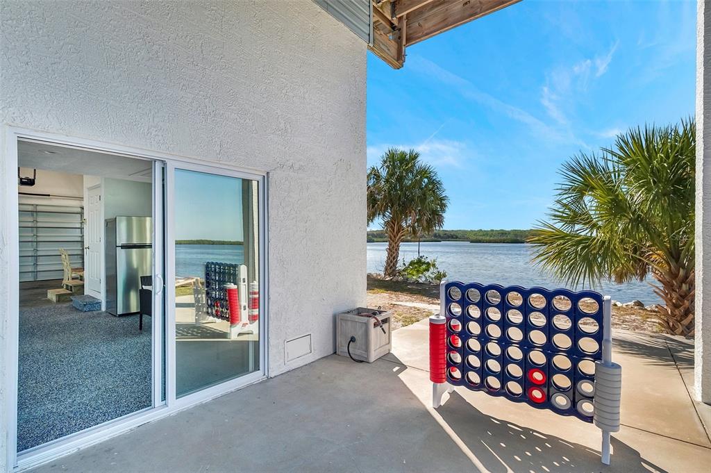 2417 Sunset Vista Drive Spring Hill, FL 34607 - Photo 31 of 61 a view of a porch with a table and chairs