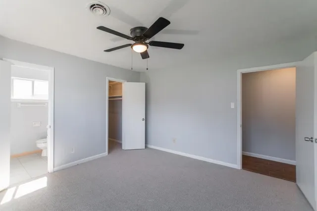 a view of an empty room and wooden floor