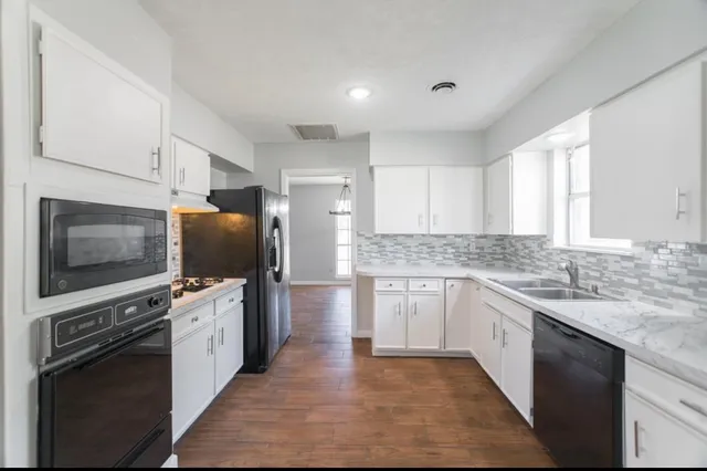a kitchen with stainless steel appliances kitchen island granite countertop a stove sink and microwave