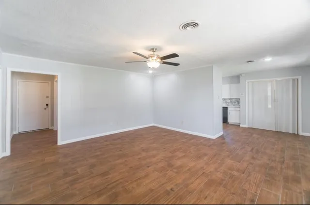 a view of an empty room with a ceiling fan