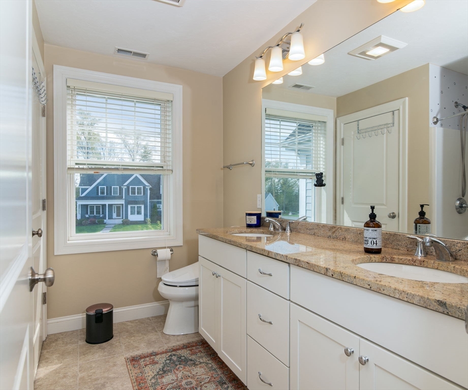 51 Tamarack Road Dracut, MA 01826 - Photo 21 of 39 a bathroom with a granite countertop sink mirror and a toilet