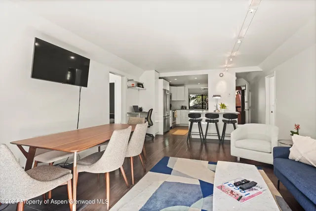 a kitchen with stainless steel appliances kitchen island granite countertop a refrigerator and microwave