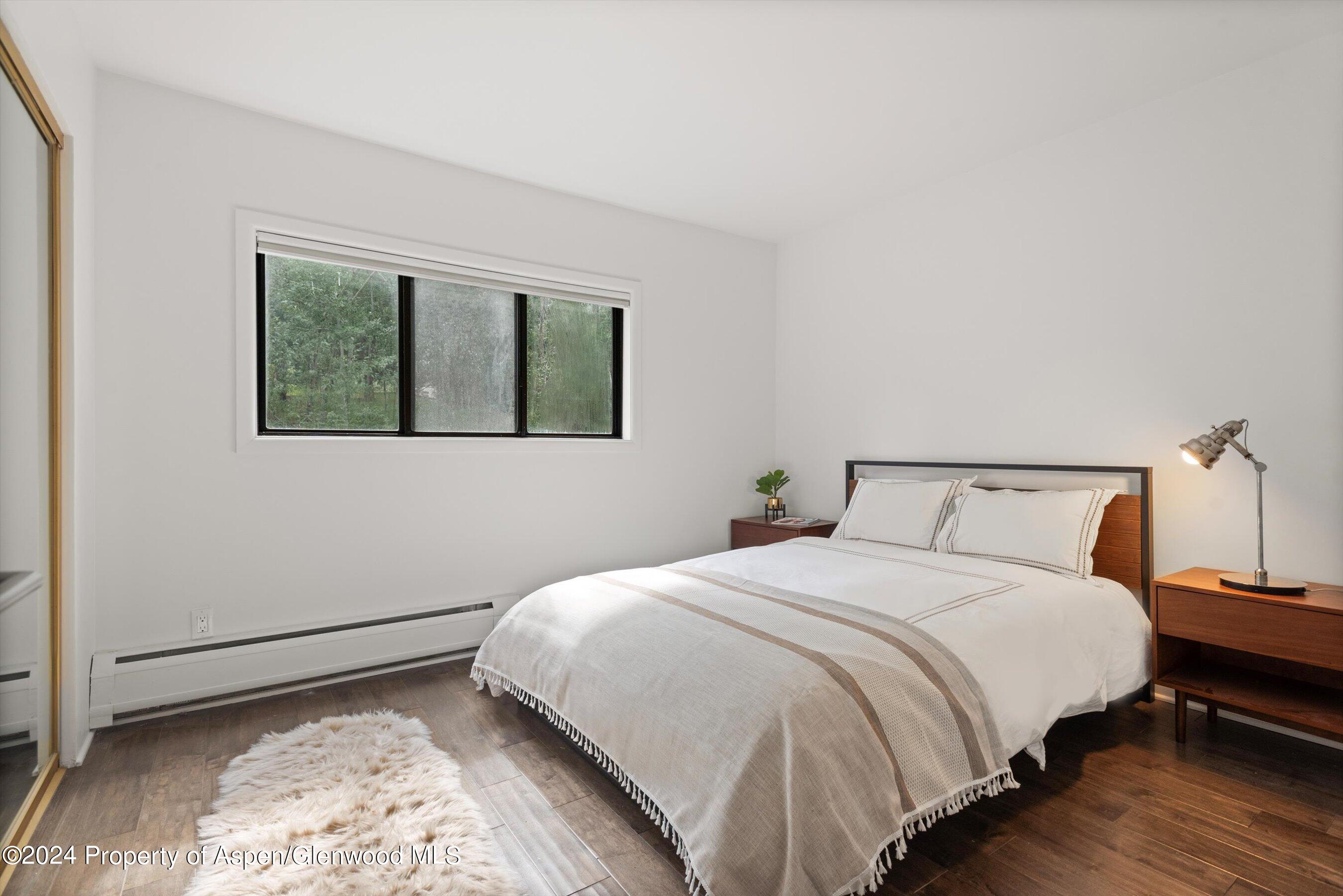 1326 Vine Street, Unit 1326 Aspen, CO 81611 - Photo 8 of 16 a bedroom with a bed and a window