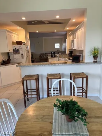 a kitchen with furniture and a potted plant