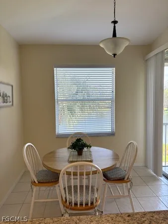 a view of a dining room with furniture and window