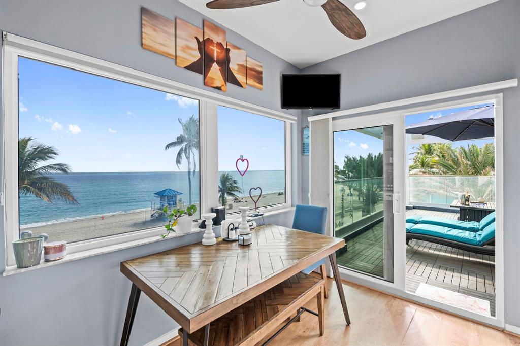 2203 North Surf Road Hollywood, FL 33019 - Photo 16 of 60 a dining room with furniture and a floor to ceiling window