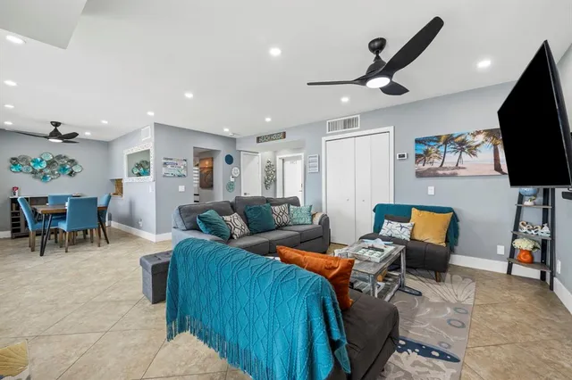 a bedroom with a bed a lamp and a flat tv screen