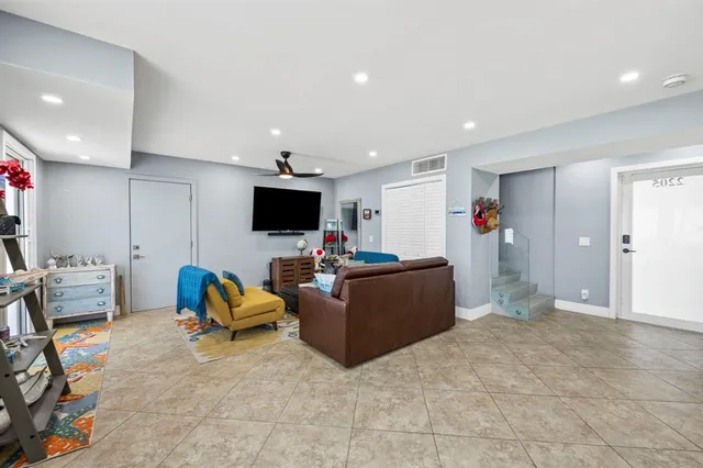 a bedroom with a large bed and a large window