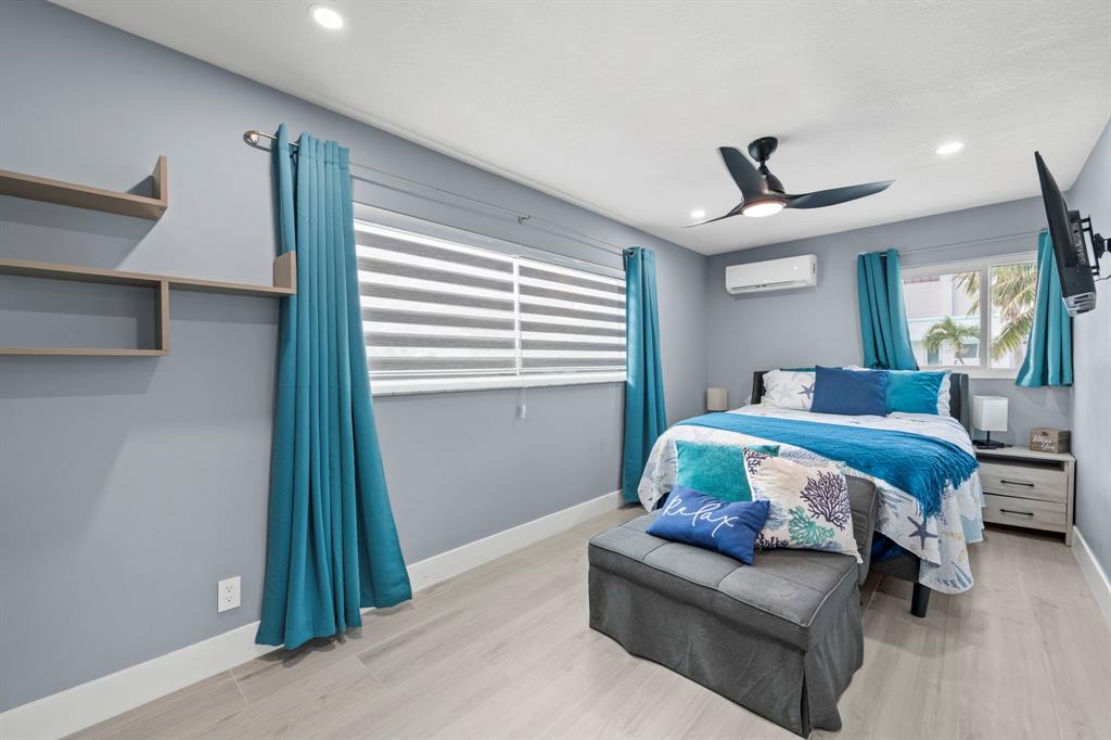 2203 North Surf Road Hollywood, FL 33019 - Photo 34 of 60 a bedroom with a bed couch and a window