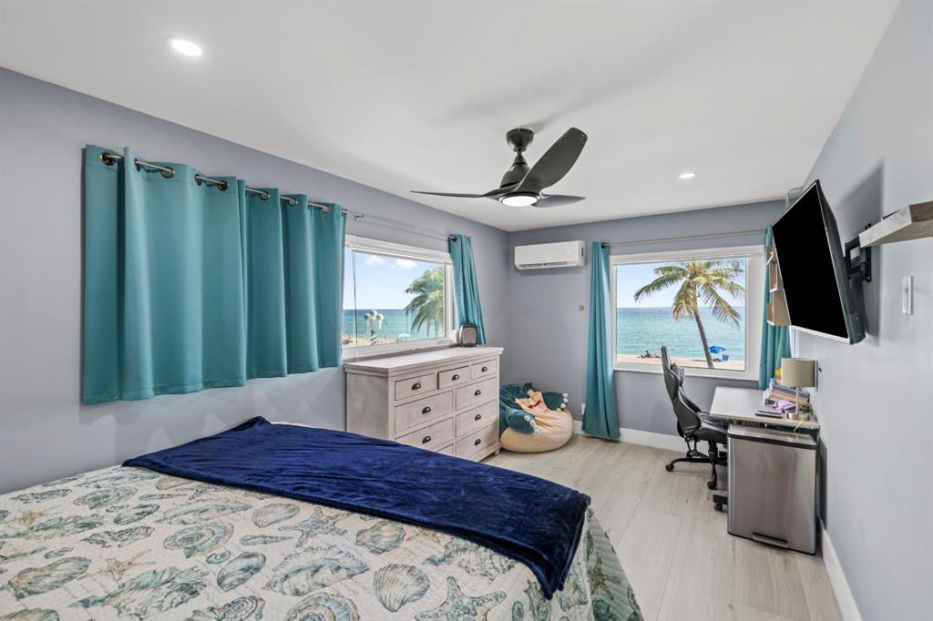 2203 North Surf Road Hollywood, FL 33019 - Photo 35 of 60 a bedroom with a bed window and flat screen tv