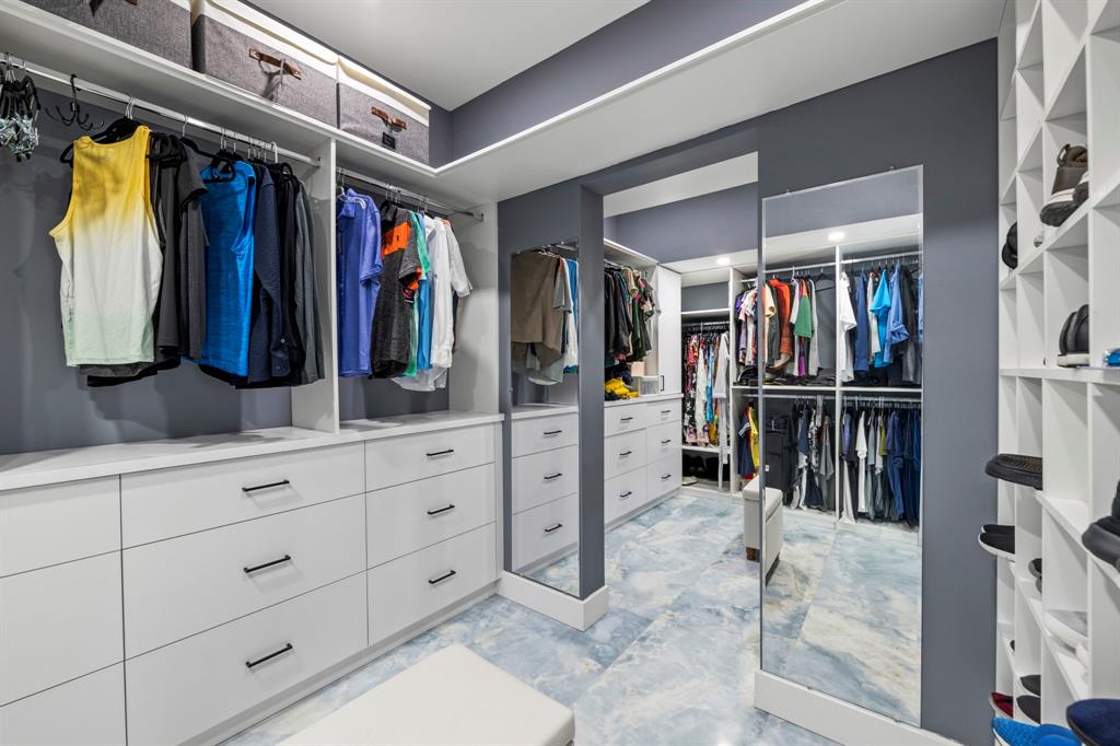 2203 North Surf Road Hollywood, FL 33019 - Photo 52 of 60 a view of walk in closet with clothes and shoes