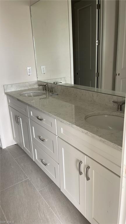 14557 Kingfisher Loop Naples, FL 34120 - Photo 11 of 27 a bathroom with a sink and a mirror