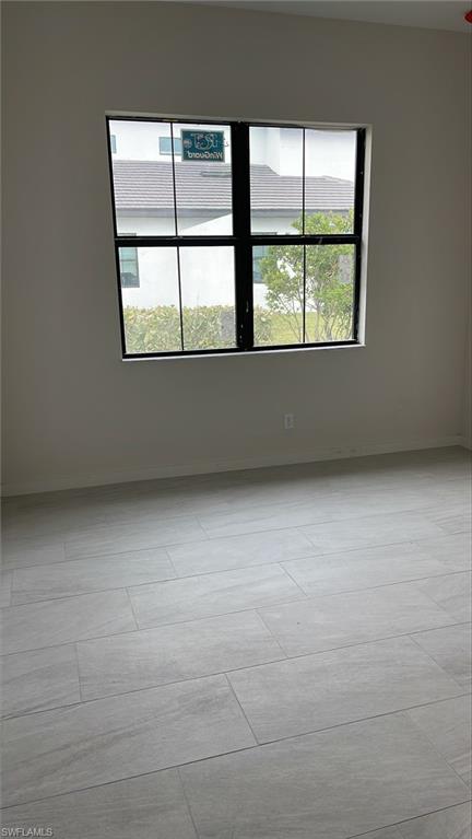 14557 Kingfisher Loop Naples, FL 34120 - Photo 14 of 27 a view of an empty room with a window